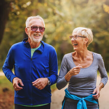 Elderly couple jogging outdoors