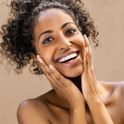 smiling woman with her hands on her cheeks