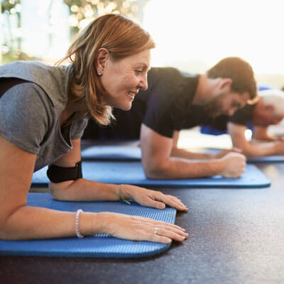 people working out on an exercise mat