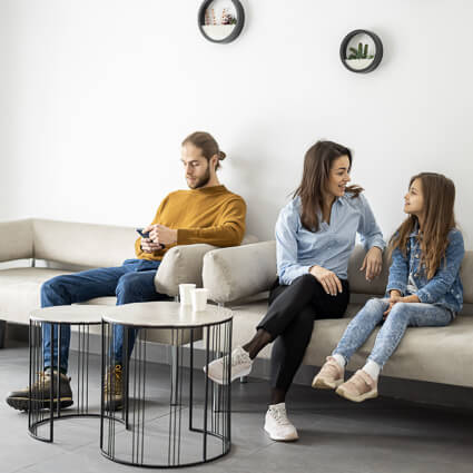 3 people sitting in a waiting room