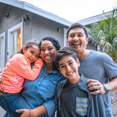 smiling family hugging one another