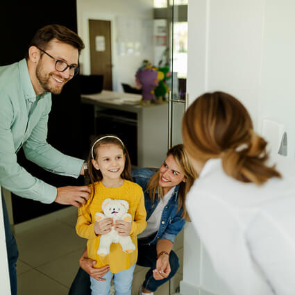 mom and dad at the dentist with their kid