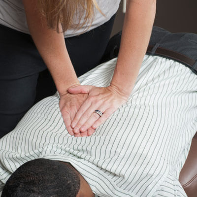chiropractor adjusting a patients back