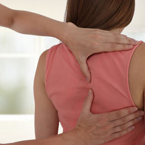 Doctor's hands on woman's back