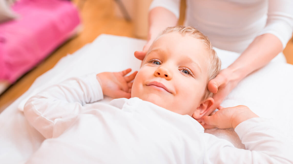 Boy getting neck adjustment