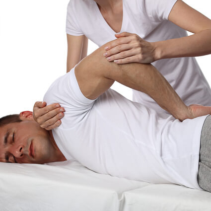 Chiropractor adjusting a male patient