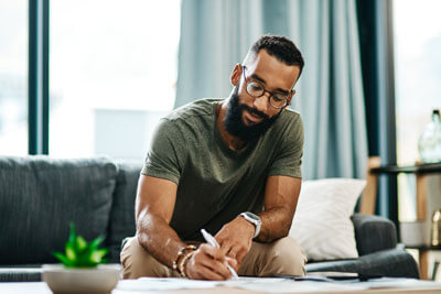 Man filling out paperwork at home