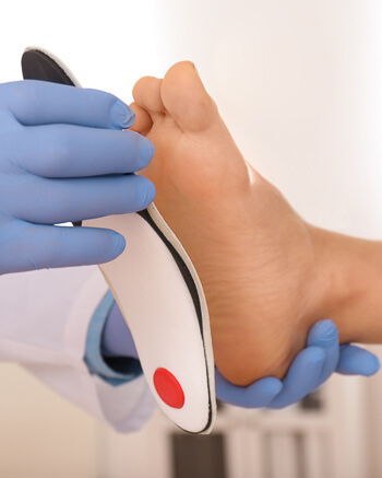 Woman being fitted for orthotics