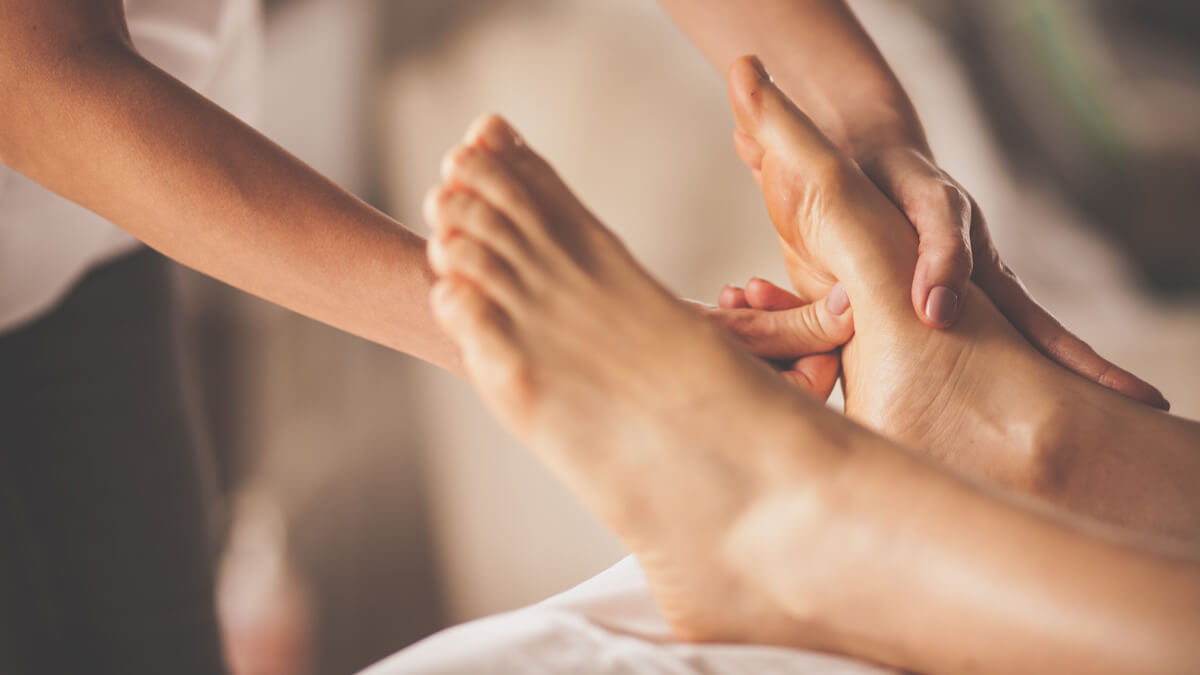 Massaging woman's foot