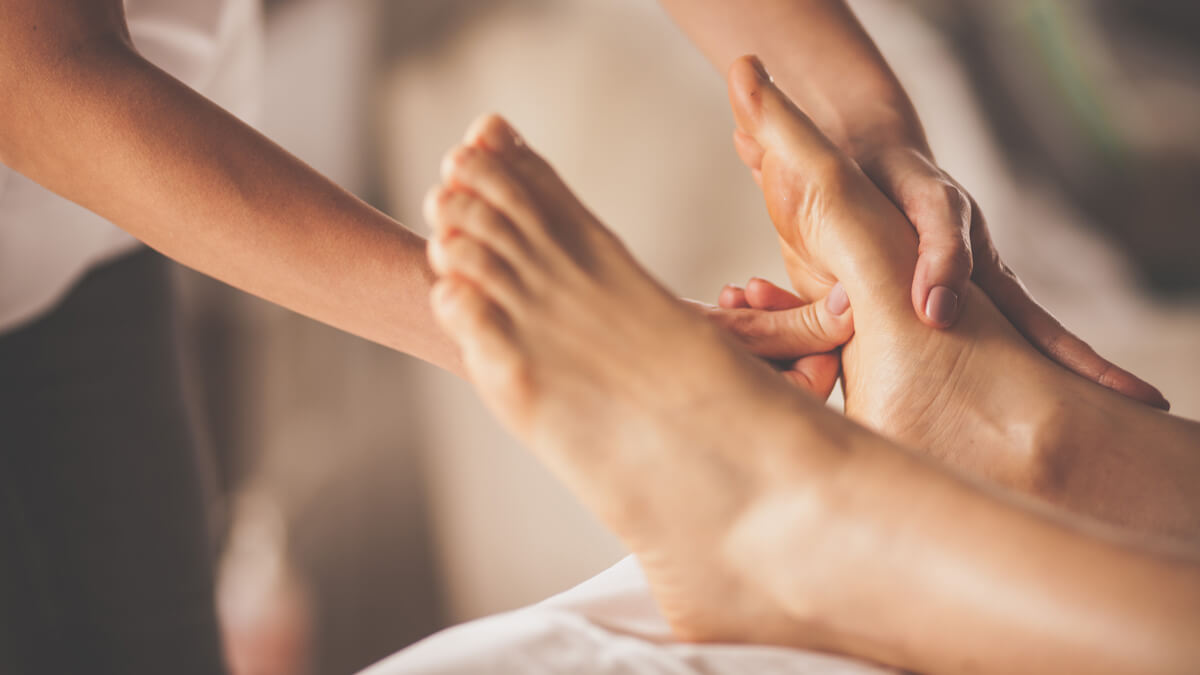 Rubbing bottom of woman's foot