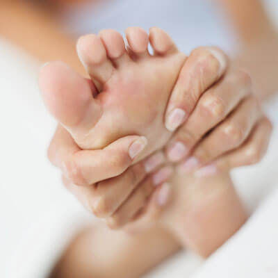 close up of hand massaging foot for reflexology in Perth