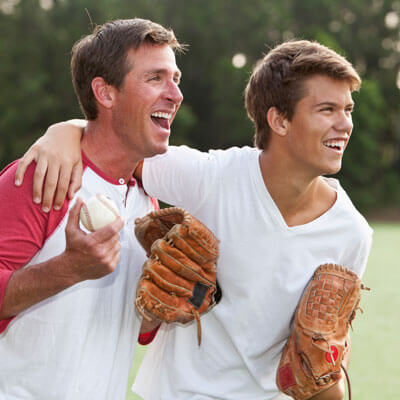 friends smiling playing baseball