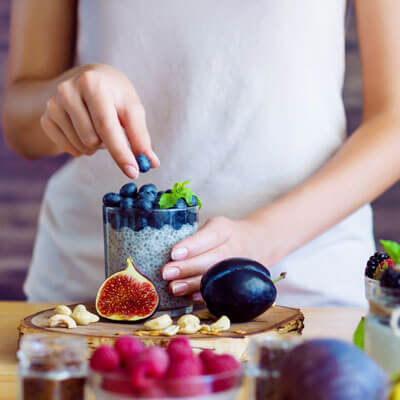 Woman making blueberry smoothie