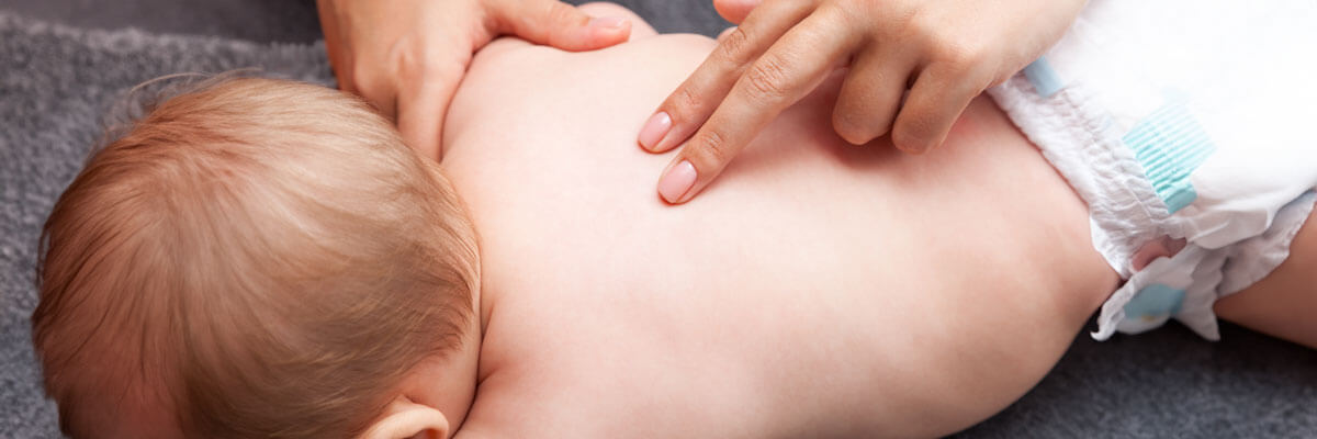 Chiropractor adjusting a baby