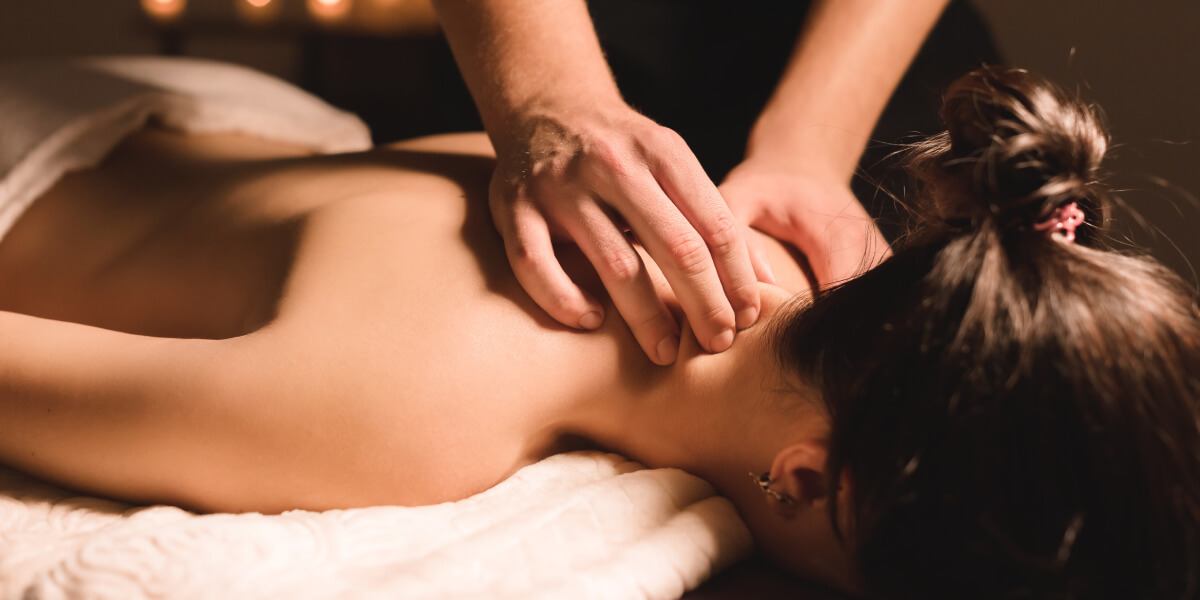Massage therapist treating a patient's neck