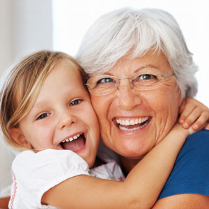 Older woman hugging little girl