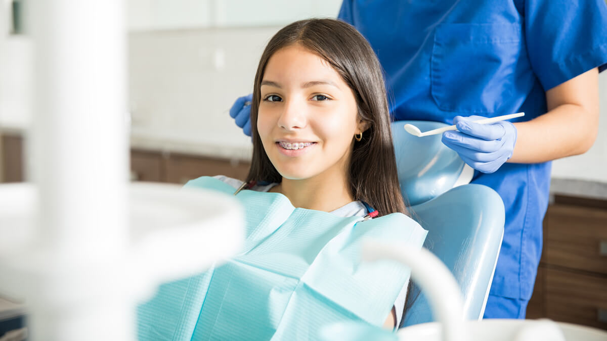 Girl with braces at dentist