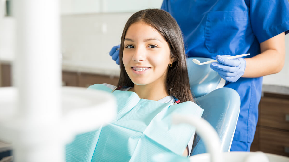 girl at dentist with braces