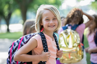 Girl smiling with backpack