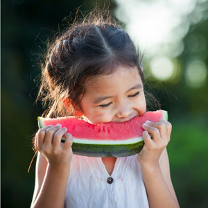 Little girl eating watermelon