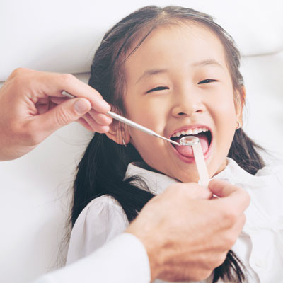 Girl getting teeth checked