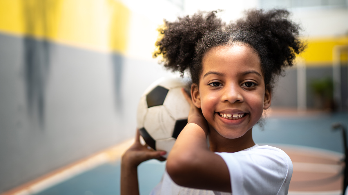 Girl holding soccer ball