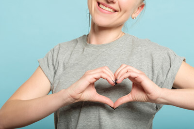 girl making heart with hands