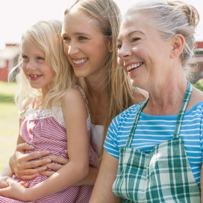 girl mom and grandmother outside smiling