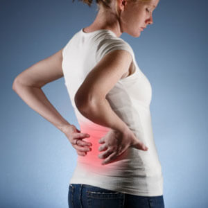 woman holding her back in pain