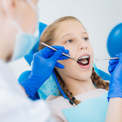 girl in a dentist office with braces