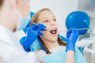 girl with braces getting a checkup
