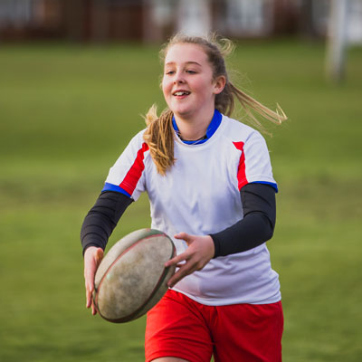 girl playing rugby
