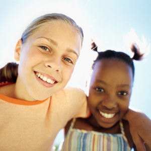 Two girls smiling together