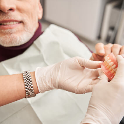 older man during denture consult