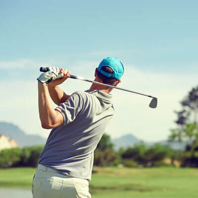 golfer swing in bright blue hat