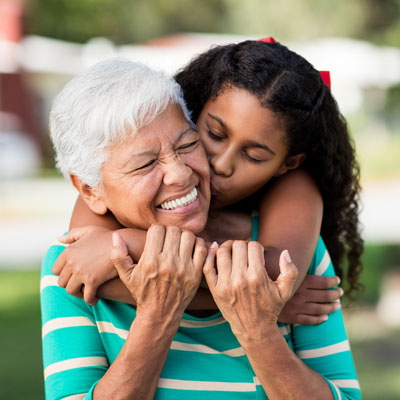 woman with granddaughter smiling