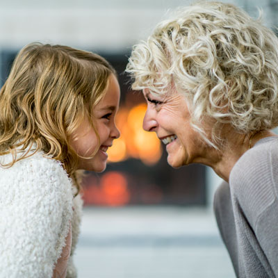 girl and grandmother looking at each other