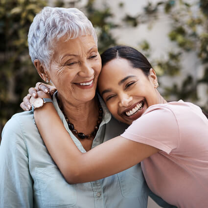 Two women hugging and laughing