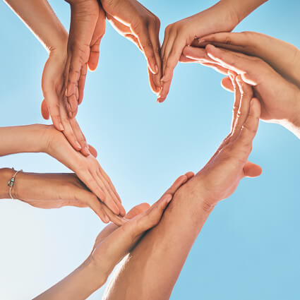 people making a heart shape with their hands
