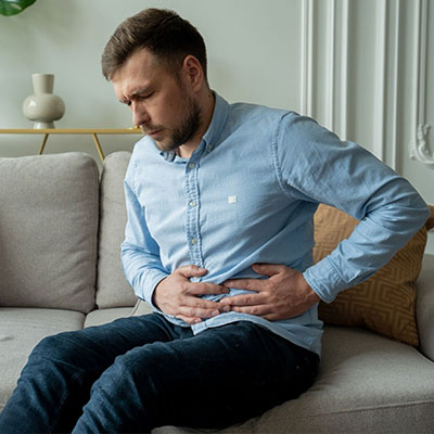 man holding stomach with pain