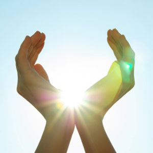 female hands grasping sun