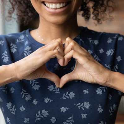 Hands making heart on chest