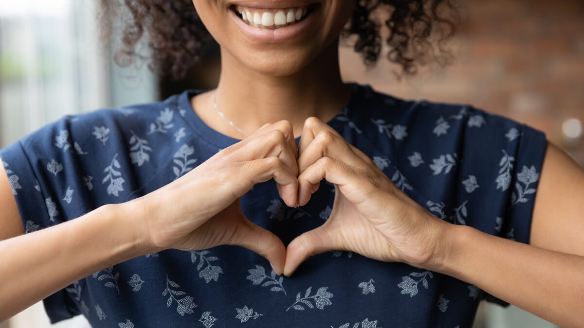 Hands making heart on chest