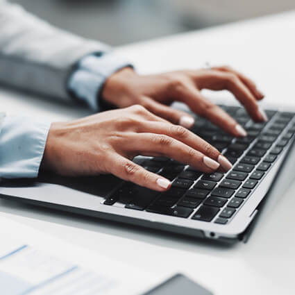 woman typing on a laptop keyboard