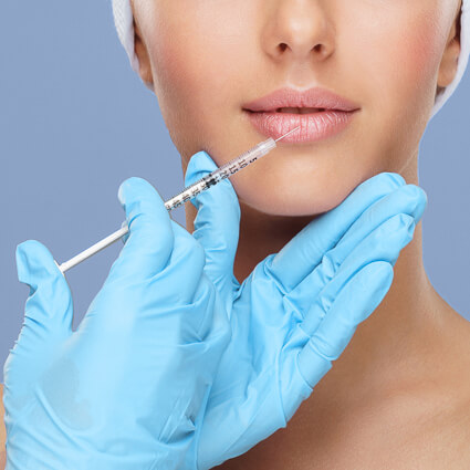 Practitioner administering a facial injectable treatment