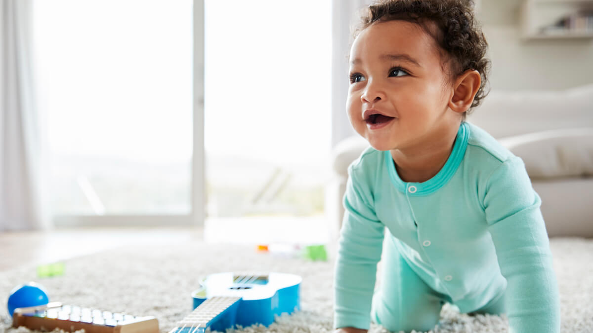 happy baby crawling and playing