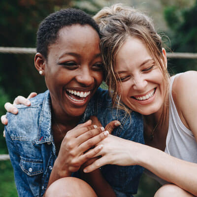 women smiling and hugging