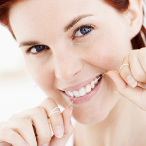 woman flossing teeth