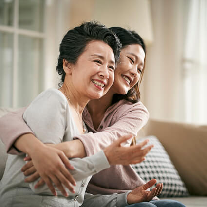 mom and daughter hugging one another
