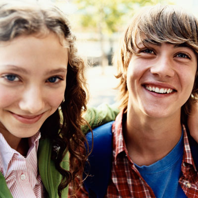 smiling kids wearing backpacks